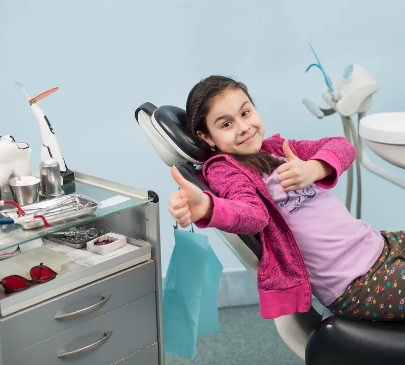 Young patient smiling during a dental checkup in Jumeirah