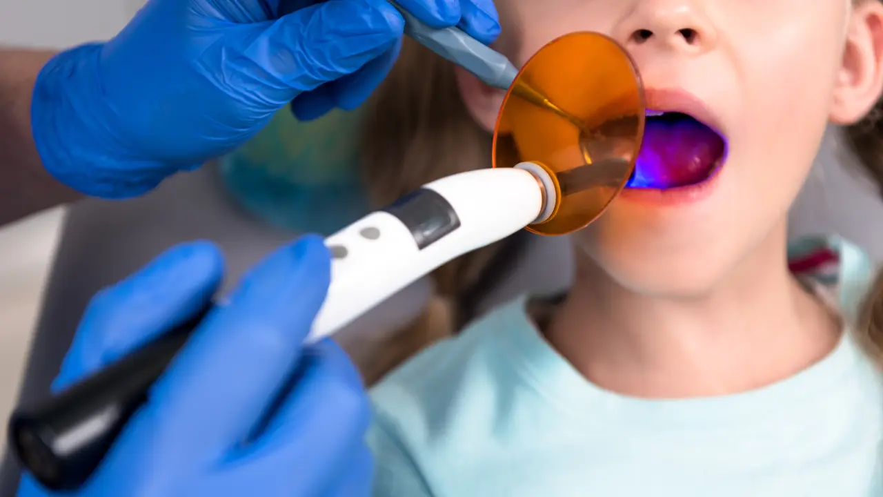 Child receiving conservative dental treatment for tooth decay during a pediatric dental visit in Dubai