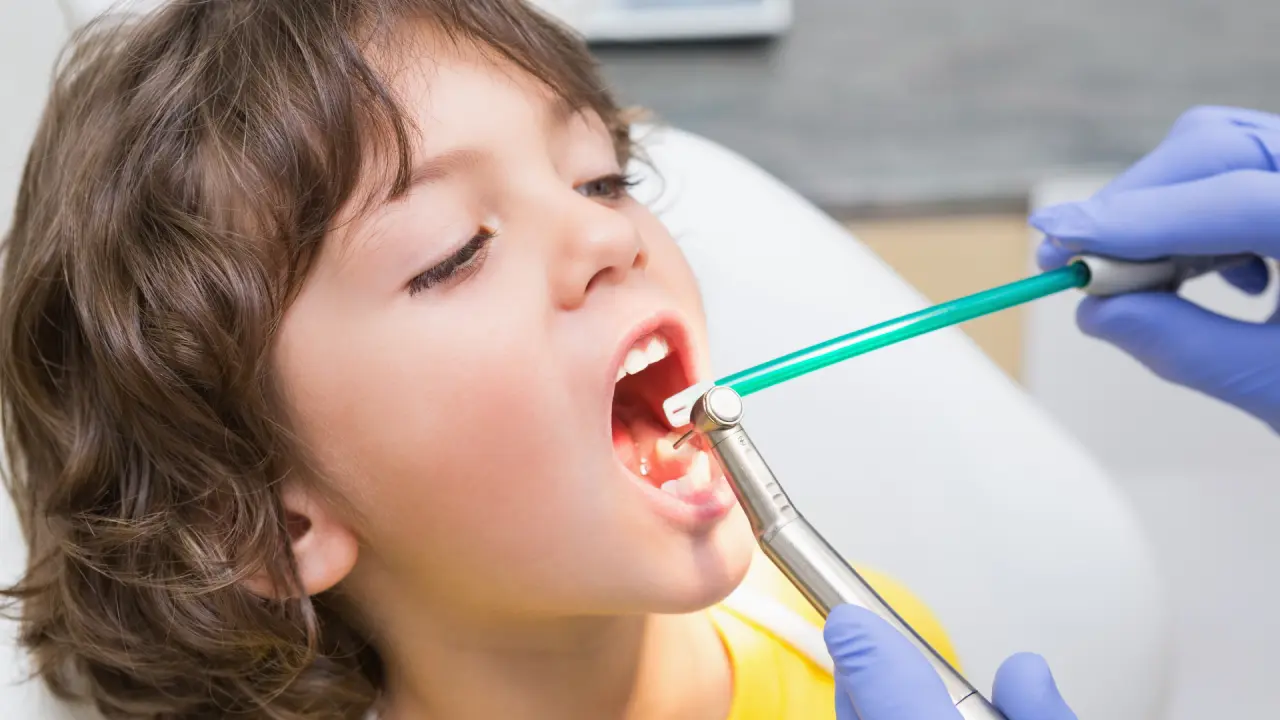 Boy child receiving a dental crown treatment in Dubai
