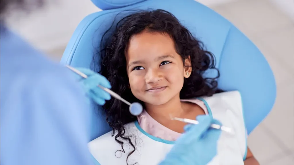 Child smiling during a gentle pediatric dental checkup at a modern dental clinic in Dubai