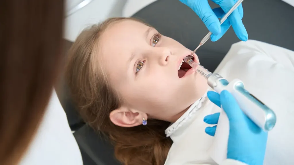 Child receiving silver diamine fluoride treatment to help stop tooth decay
