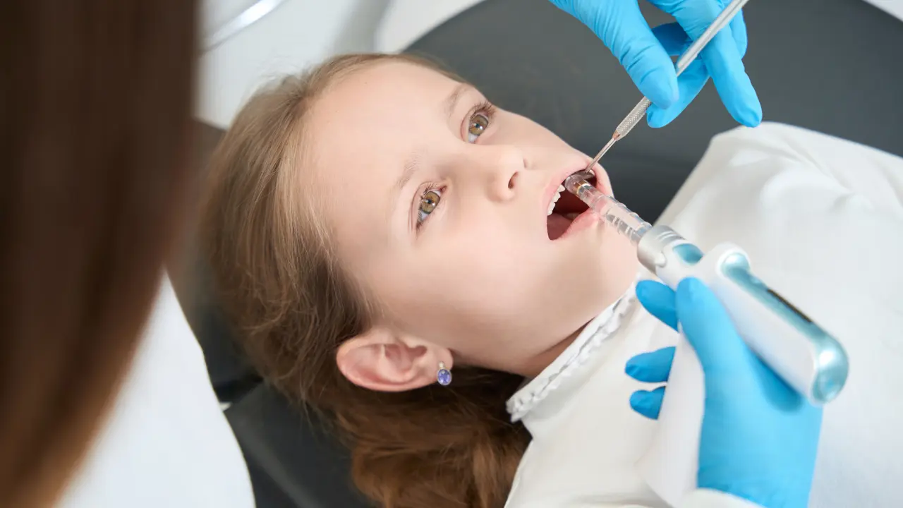 Child receiving silver diamine fluoride treatment to help stop tooth decay