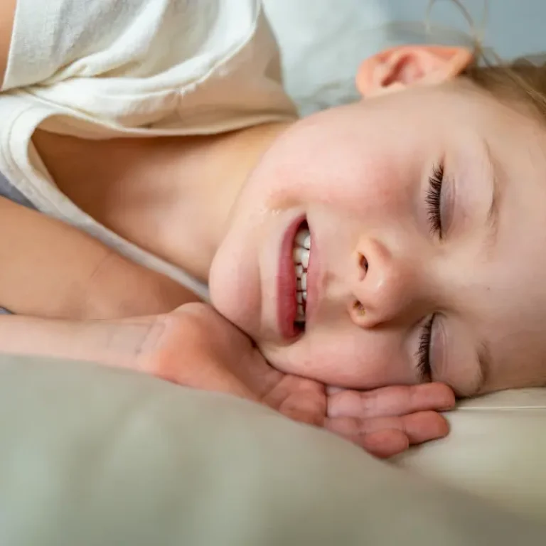 Child sleeping with clenched teeth at night